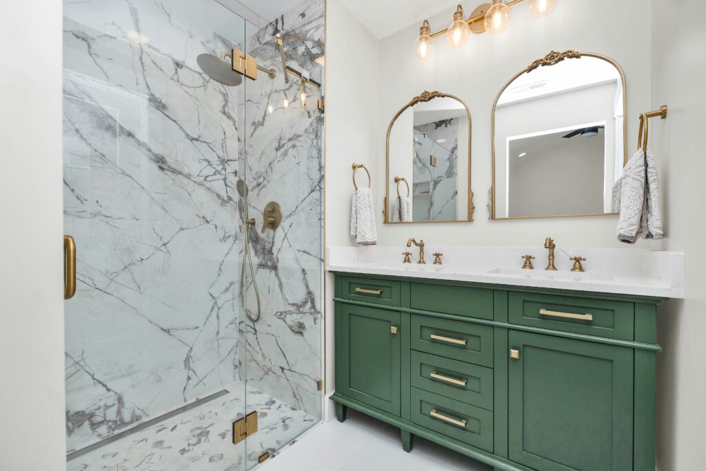 Bathroom remodel with marble tile walls and green vanity in Vancouver WA